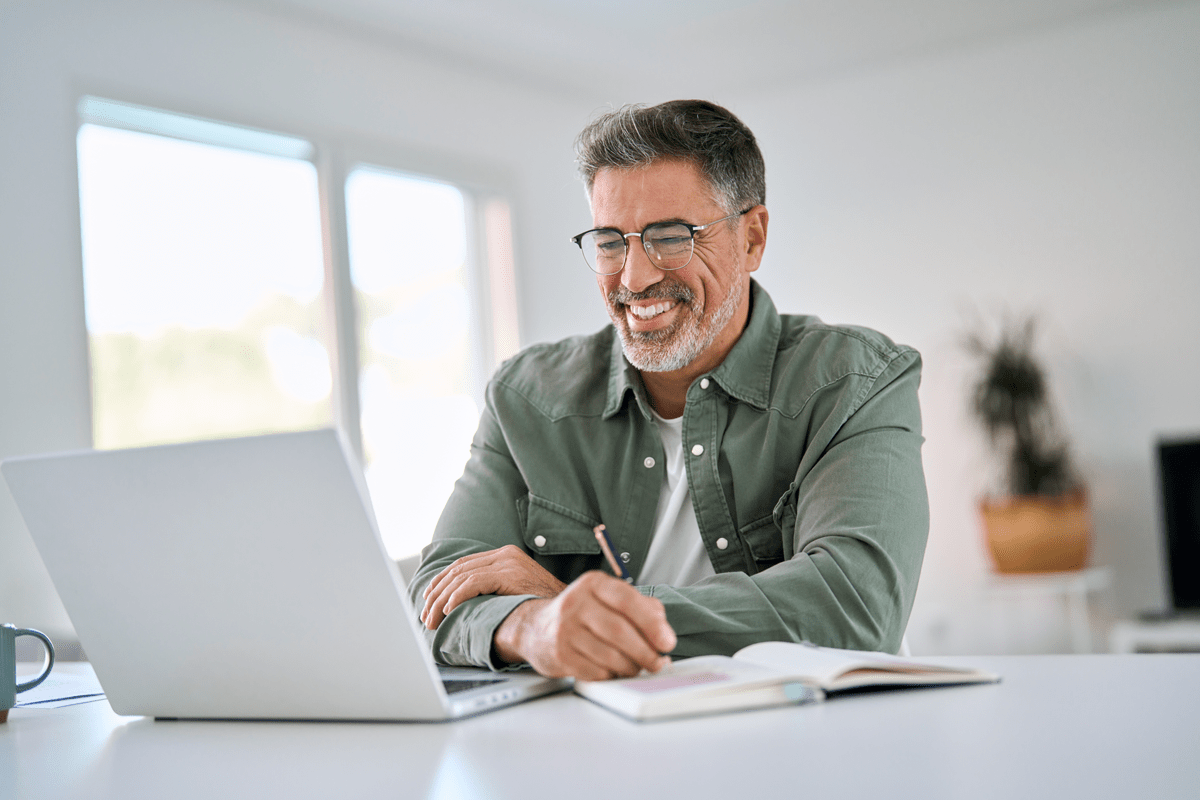 happy middle aged man using laptop computer writin 2025 02 11 15 56 41 utc